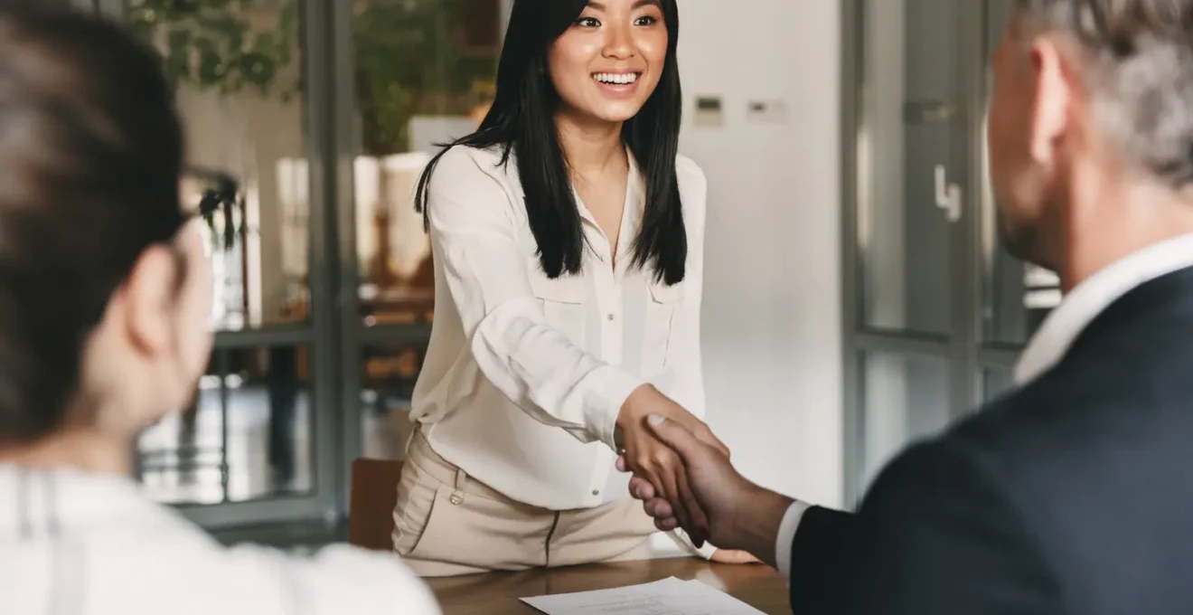 Professional candidate working on assessment exercise materials at a table in a modern office assessment room